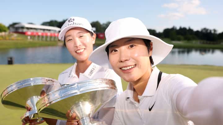 MIDLAND, MICHIGAN - JUNE 29: Jin Hee Im and Somi Lee of South Korea imitate a selfie while posing their trophies after the final round of the Dow Championship 2025 at Midland Country Club on June 29, 2025 in Midland, Michigan.