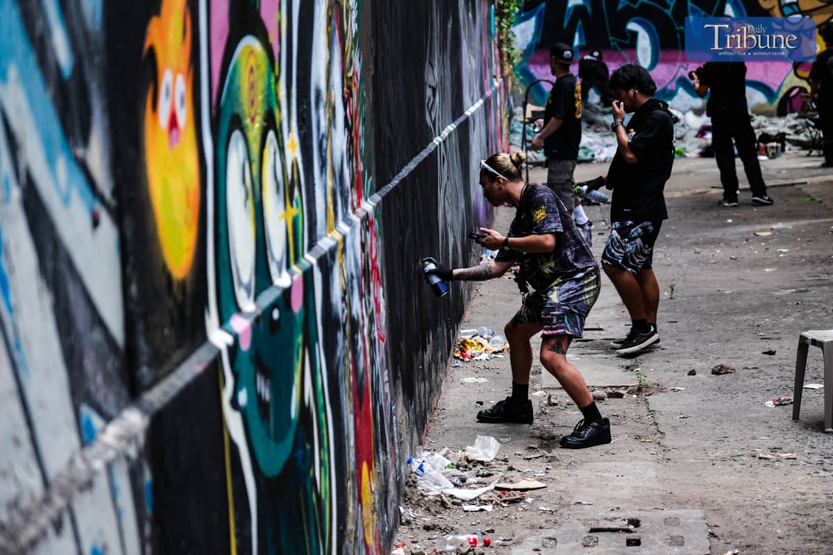 RJ, a fellow organizer of Picnic Games, creates his own art at one of it walls during Picnic Games. PHOTO BY YUMMIE DINGDING