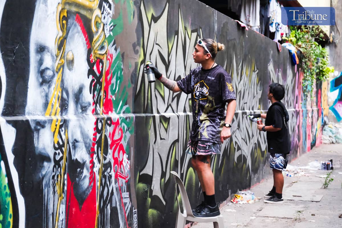 RJ, a fellow organizer of Picnic Games, creates his own art at one of it walls during Picnic Games. PHOTO BY YUMMIE DINGDING