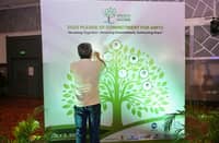A SUPPORTER of the Annual Million Trees Challenge sticks his organization’s logo on the pledging board during the AMTC Recognition and Awarding ceremony on 2 July at the Celebrity Club in Quezon City.