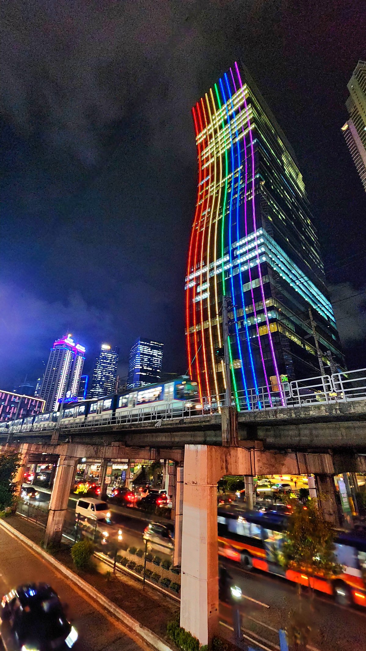 The Mega Tower with rainbow lights, illuminating the Ortigas Center-Crossing area in Mandaluyong City.