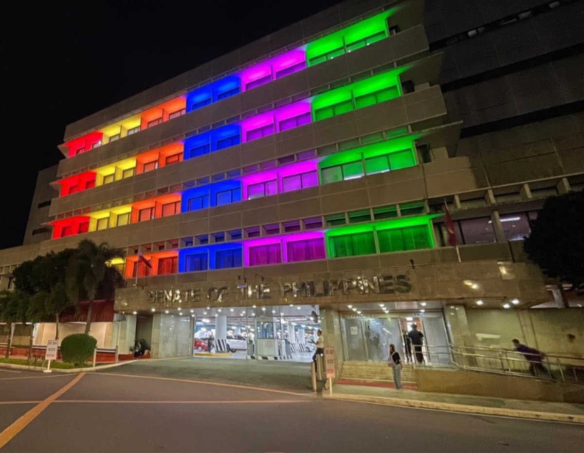 The Senate of the Philippines building with rainbow lights.