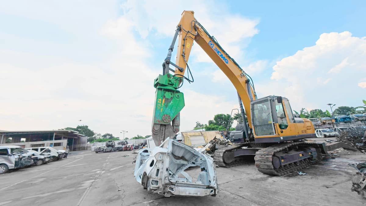 A MANGLED car body gets crushed at Standard Insurance’s Cavite facility.