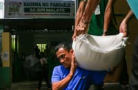WORKERS unload sacks of rice at the Kadiwa ng Pangulo outlet on San Andres Street, Manila, on Monday. Priced at just P20 per kilo with a 10-kilo purchase cap, the rice is part of the ‘Benteng Bigas Meron Na! (BBM Na!)’ program for vulnerable sectors.