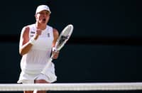 IGA Swiatek celebrates after pulling off a 6-2, 6-0 win over Belinda Bencic in the women’s event semifinals of the Wimbledon Championships.