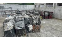 Compressed scrap metals from dismantled body panels ready for metal recycling.