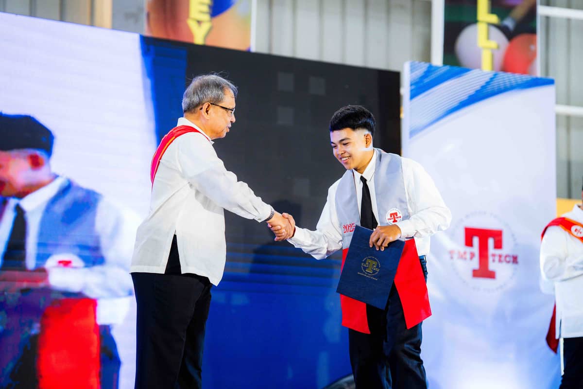 TMP Tech president Jose Maria Aligada awards a training certificate to a graduating student.