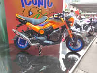 A Honda Navi grabs attention with its custom orange and blue setup at the launch event.