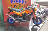 A Honda Navi grabs attention with its custom orange and blue setup at the launch event.