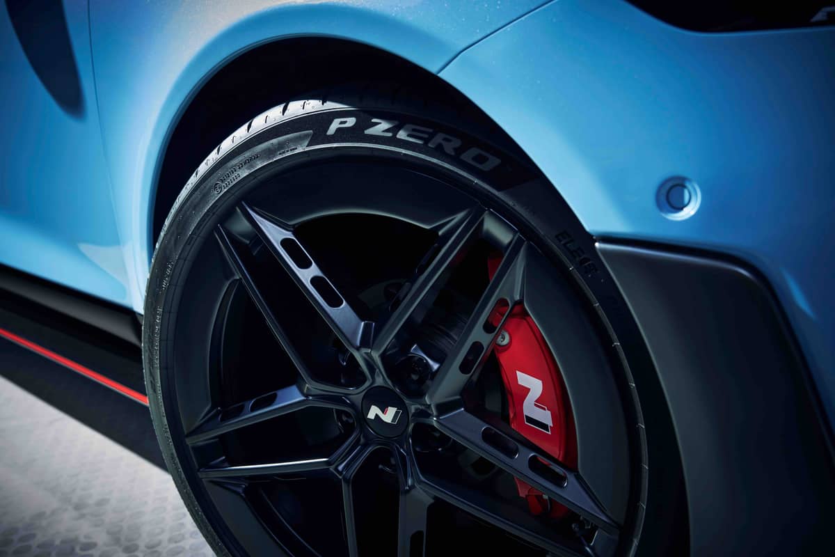 CLOSE-UP of the custom HN-marked Pirelli P-Zero tires and red N brake calipers.
