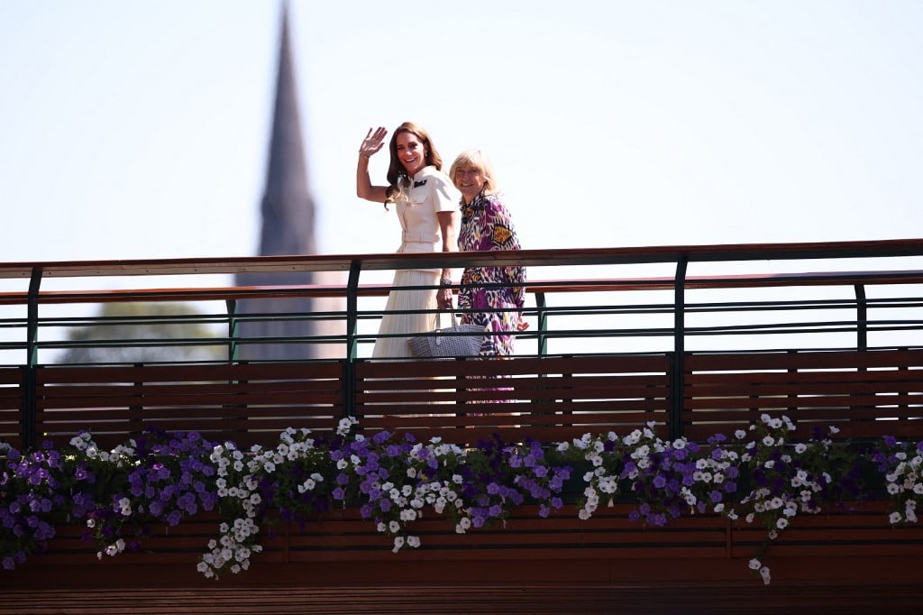 Britain's Catherine, Princess of Wales (L) waves as she crosses the bridge towards Centre Court to attend the women's singles final tennis match on the thirteenth day of the 2025 Wimbledon Championships at The All England Lawn Tennis and Croquet Club in Wimbledon, southwest London, on July 12, 2025.