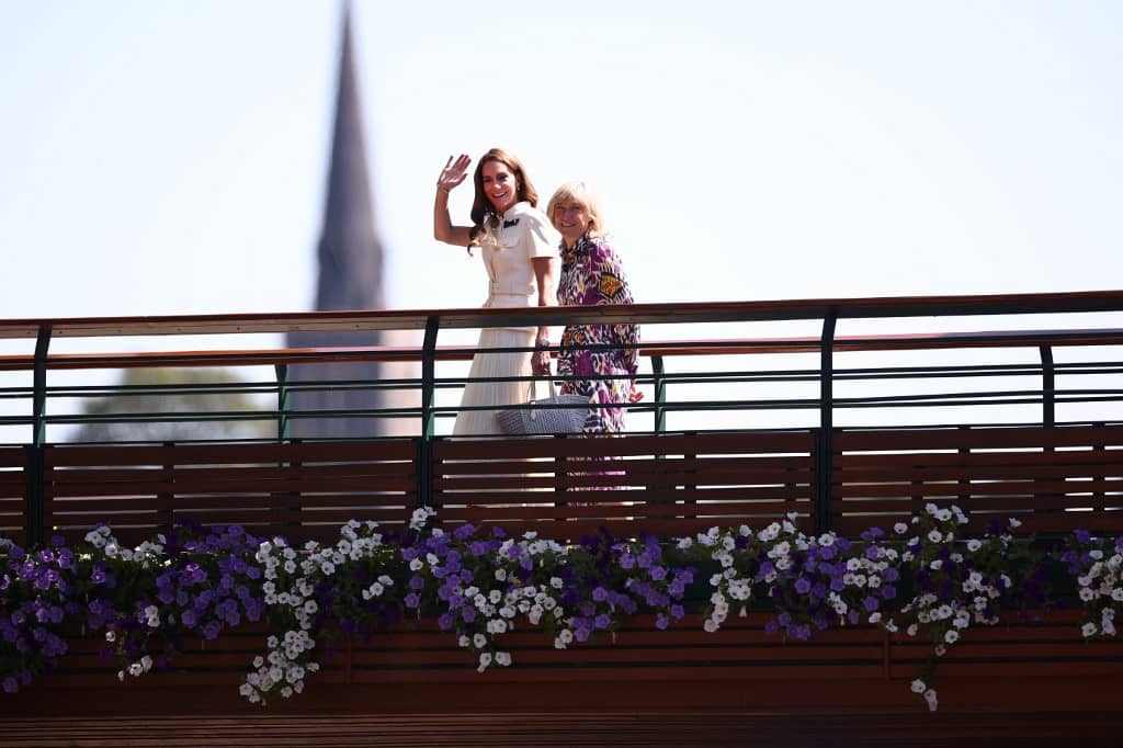 Britain's Catherine, Princess of Wales (L) waves as she crosses the bridge towards Centre Court to attend the women's singles final tennis match on the thirteenth day of the 2025 Wimbledon Championships at The All England Lawn Tennis and Croquet Club in Wimbledon, southwest London, on July 12, 2025.
