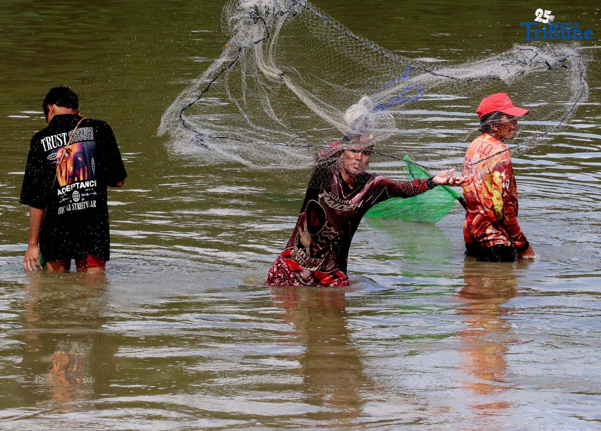 Fishers in Santa Maria, Bulacan cast traditional nets into the Macaiban Floodway to catch freshwater tilapia—sustaining both their livelihood and daily food supply.