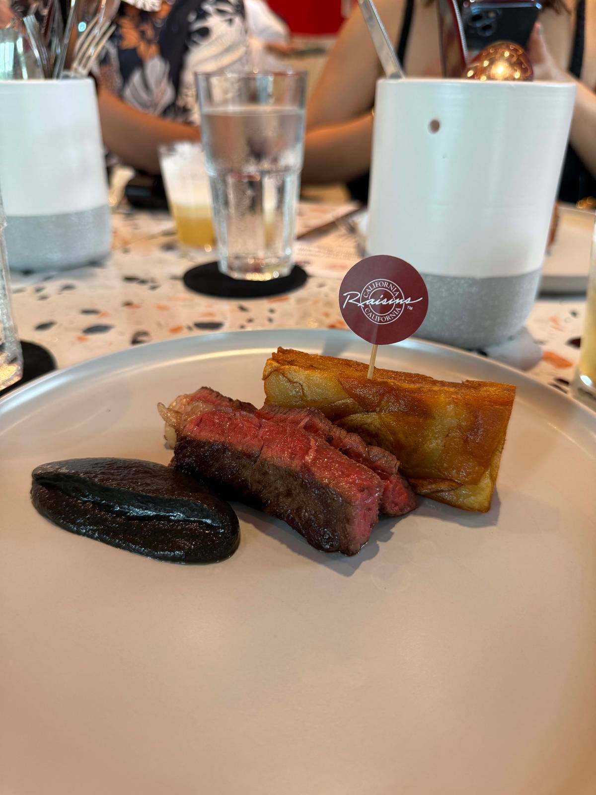 Steak and Potato Pave with California Raisin and Roasted Eggplant Sauce.