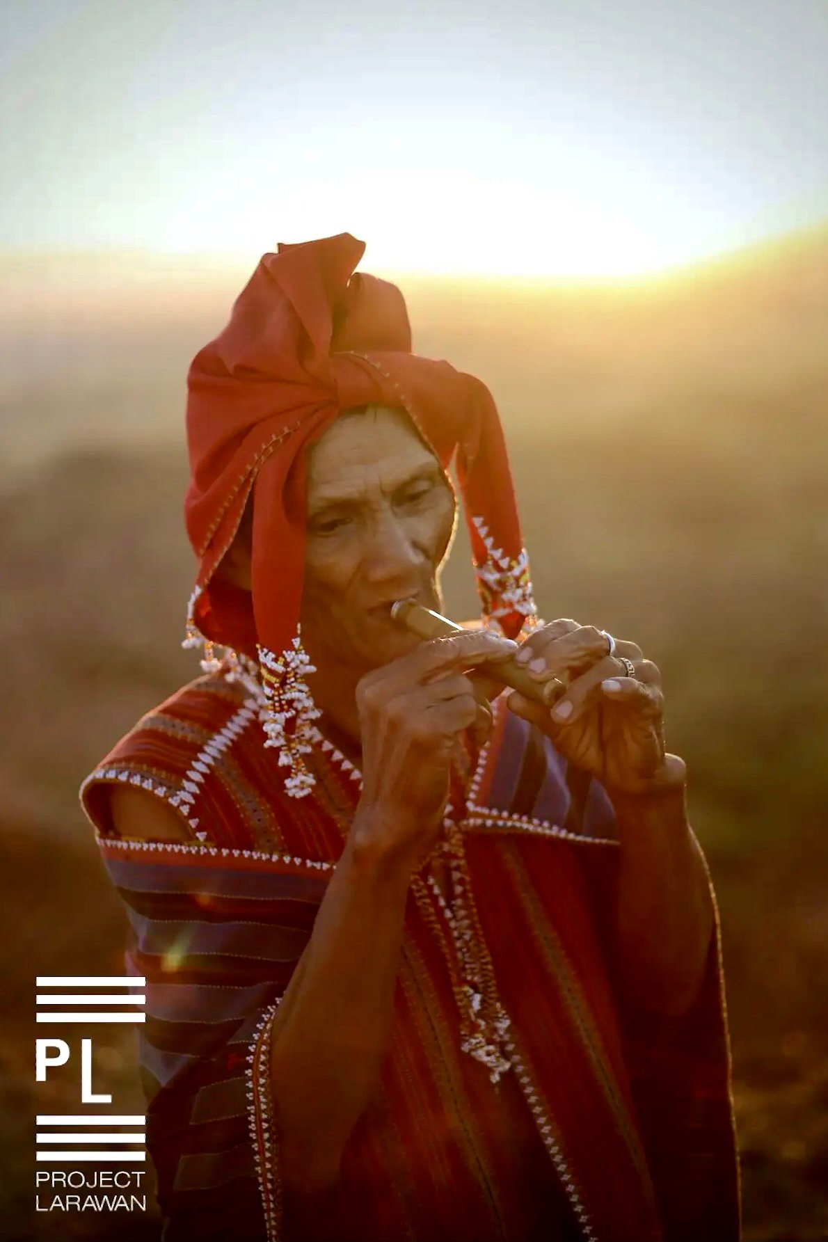 A Ga’dang musician plays the paliot (flute) to signal a new day in Simmacbot, Paracelis, Mountain Province. Photo by Gabriel Malvar.