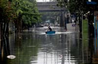 A man uses a small boat to cross floodwaters at N.S. Amoranto Street corner Araneta Avenue in Quezon City on Saturday, 19 July 2025, after continuous rains brought by the Habagat intensified by Severe Tropical Storm Crising.