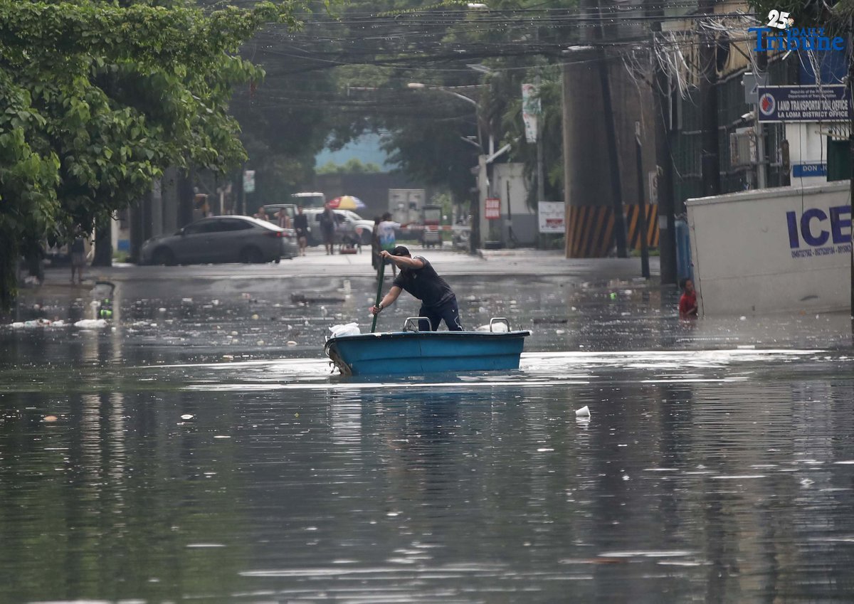 A man uses a small boat to cross floodwaters at N.S. Amoranto Street corner Araneta Avenue in Quezon City on Saturday, 19 July 2025, after continuous rains brought by the Habagat intensified by Severe Tropical Storm Crising.