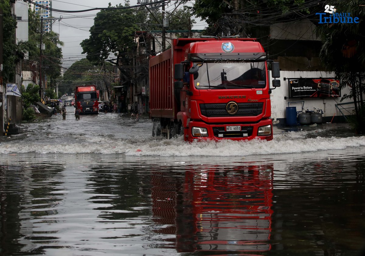 Motorists navigate floodwaters at Maria Clara Street corner Araneta Avenue in Quezon City on Saturday, 19 July 2025, following continuous rains brought by the Habagat and intensified by Severe Tropical Storm Crising.