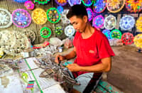 A parol maker crafts a parol at a shop in San Fernando, Pampanga.