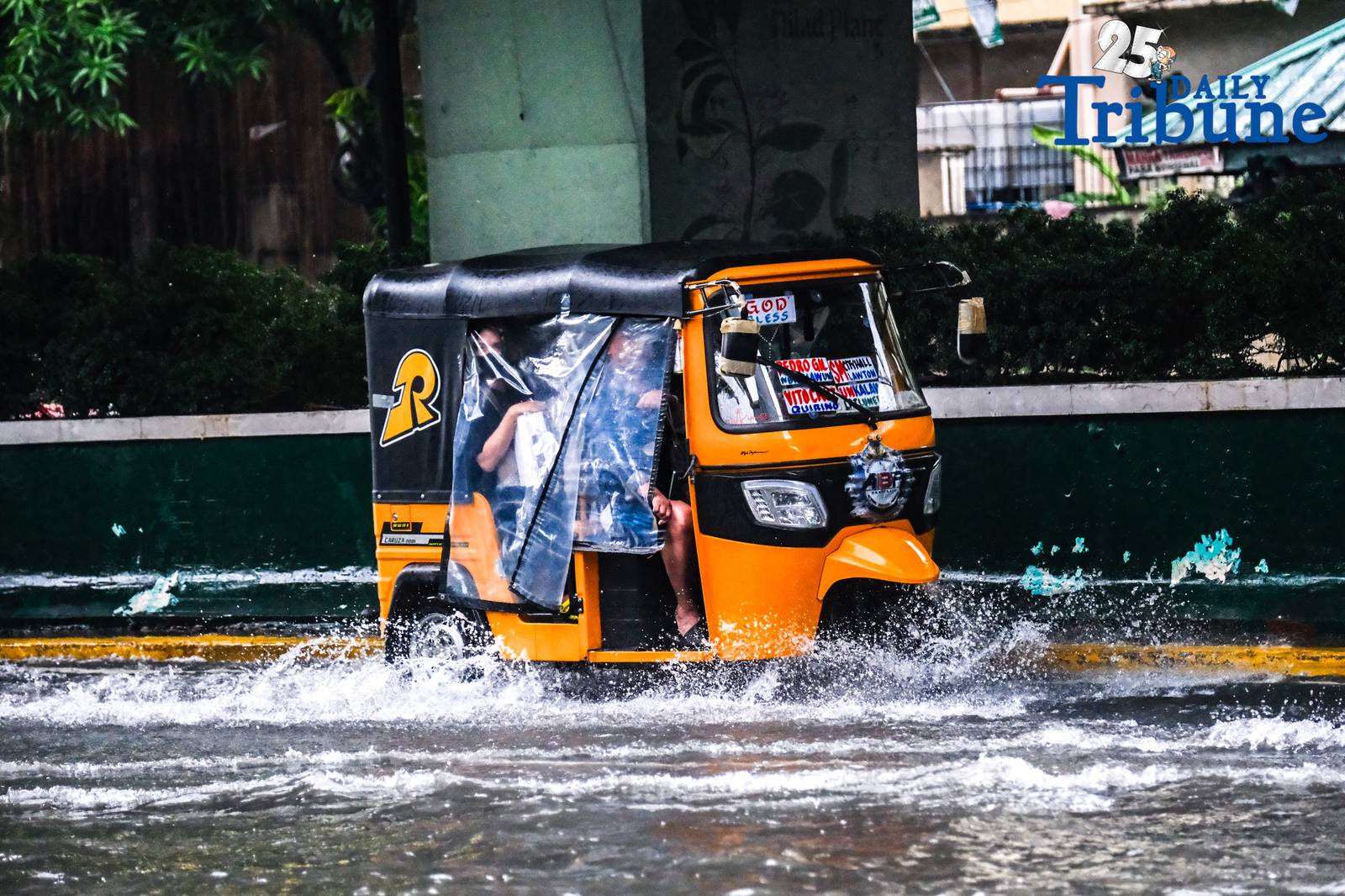 Commuters go about their day in Manila despite the unrelenting downpour.