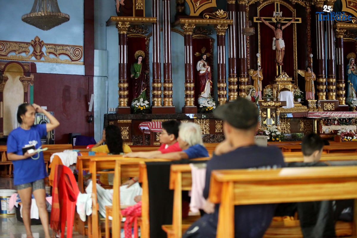 Evacuees take temporary shelter at Santa Lucia Parish in Barangay Sta. Lucia, Novaliches, Quezon City on Tuesday, July 22, 2025, after rising waters from Tullahan River submerged homes amid nonstop rains brought by the southwest monsoon.