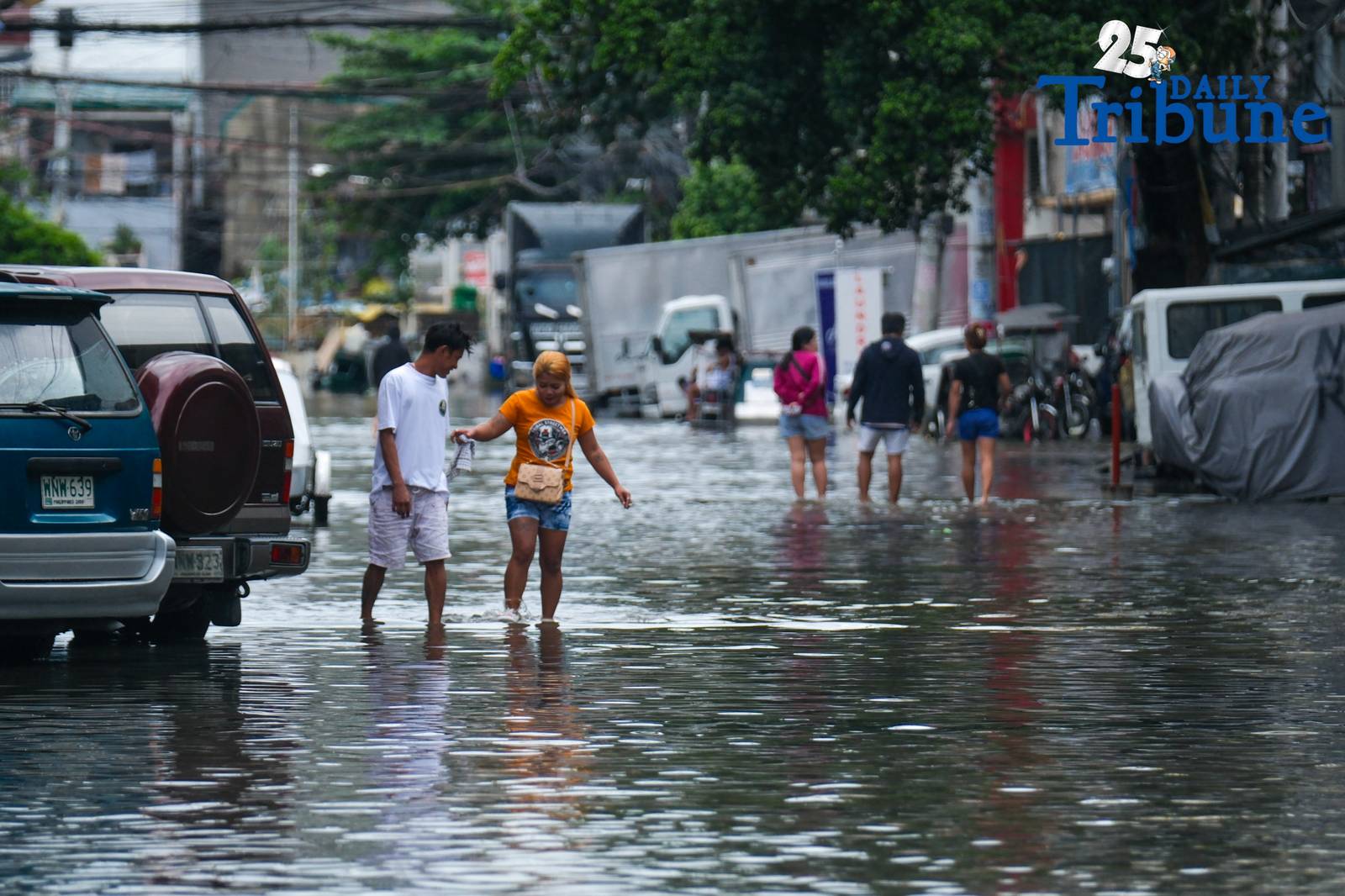 Commuters go about their day in Manila despite the unrelenting downpour.
