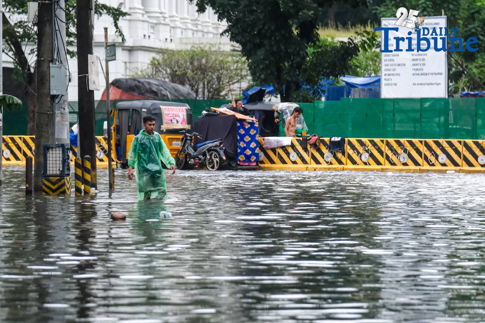 Commuters go about their day in Manila despite the unrelenting downpour.