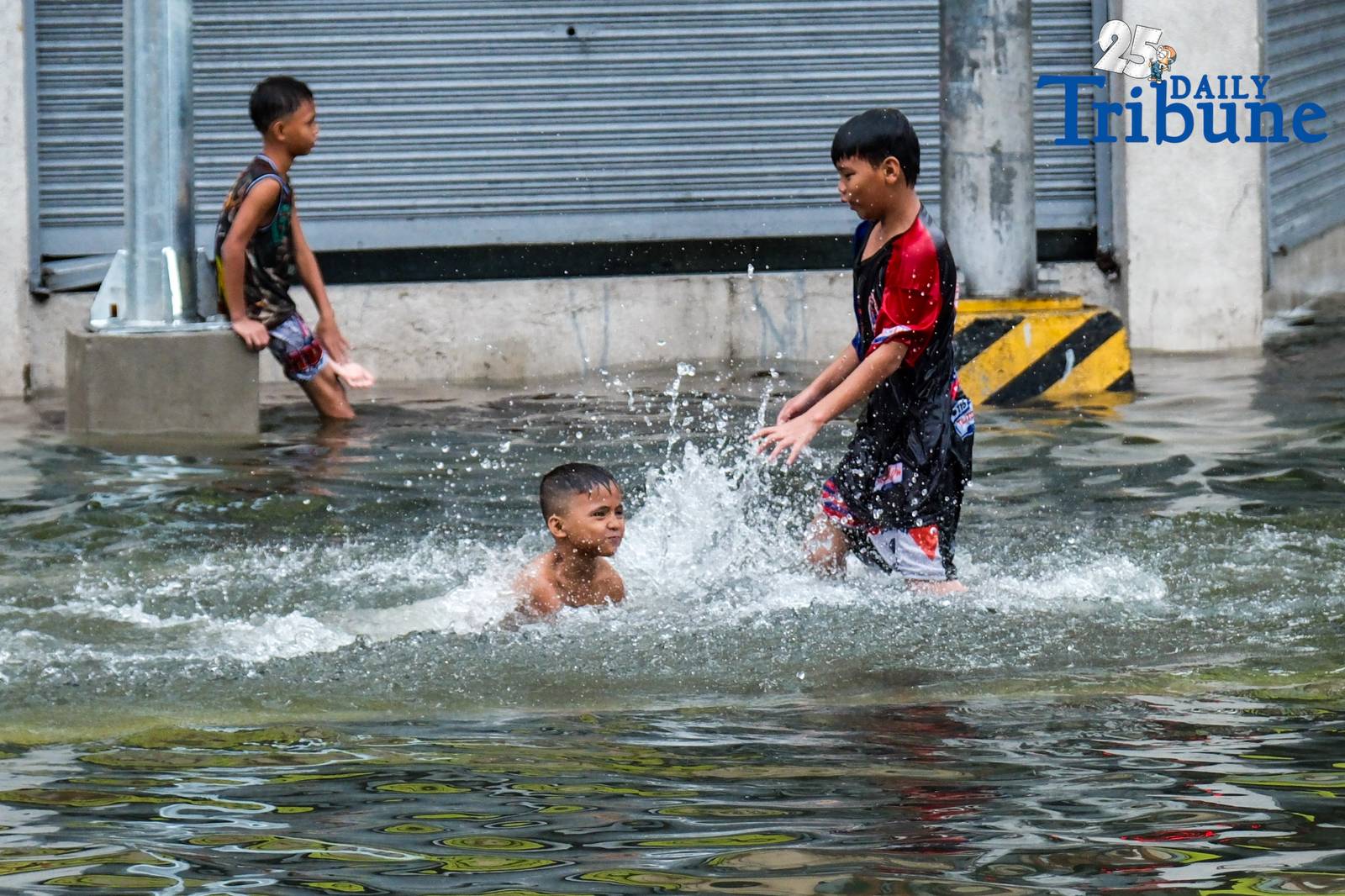 Commuters go about their day in Manila despite the unrelenting downpour.