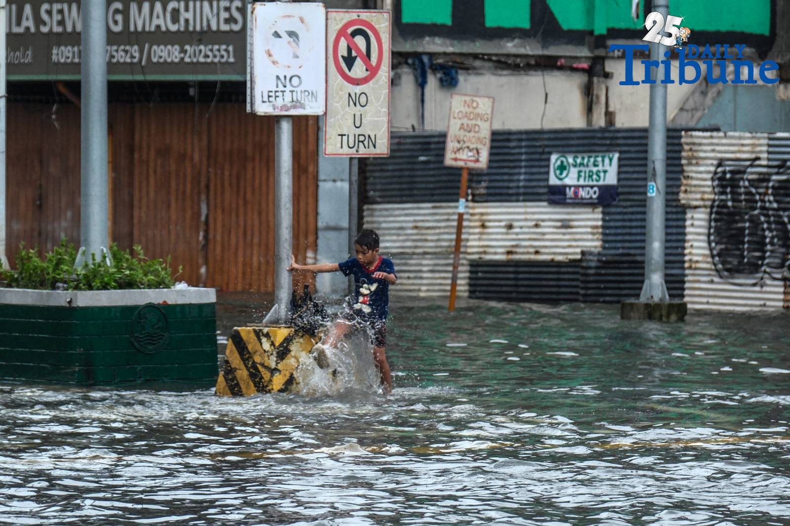 Commuters go about their day in Manila despite the unrelenting downpour.