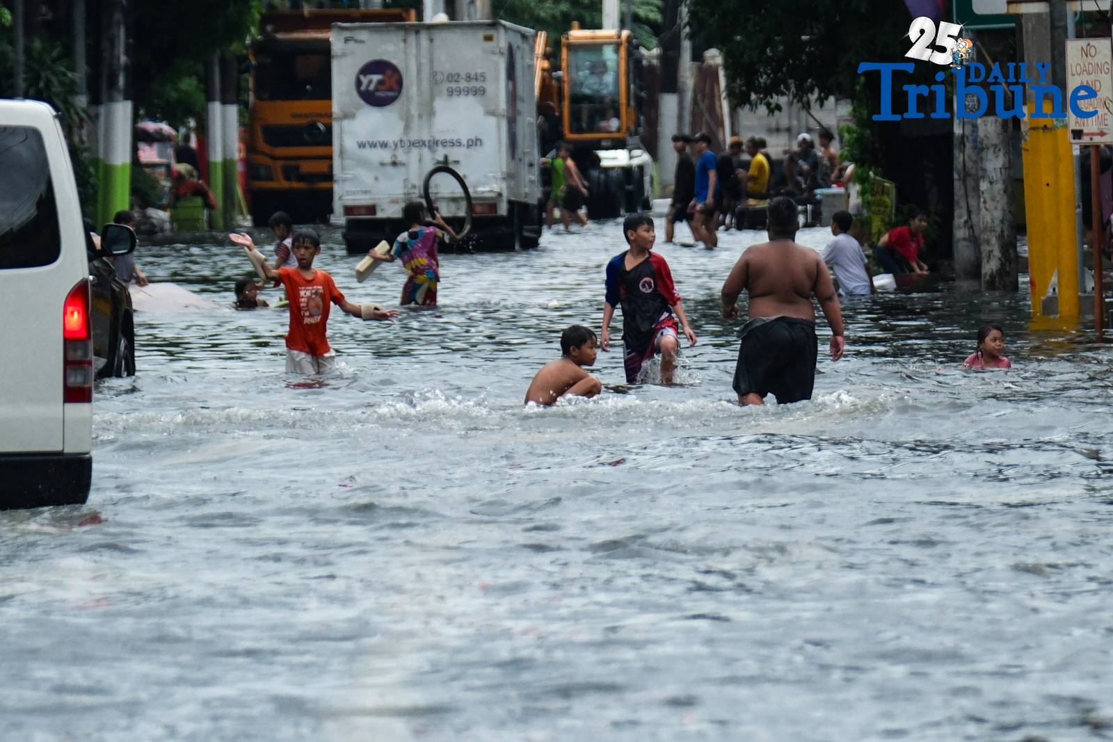Commuters go about their day in Manila despite the unrelenting downpour.