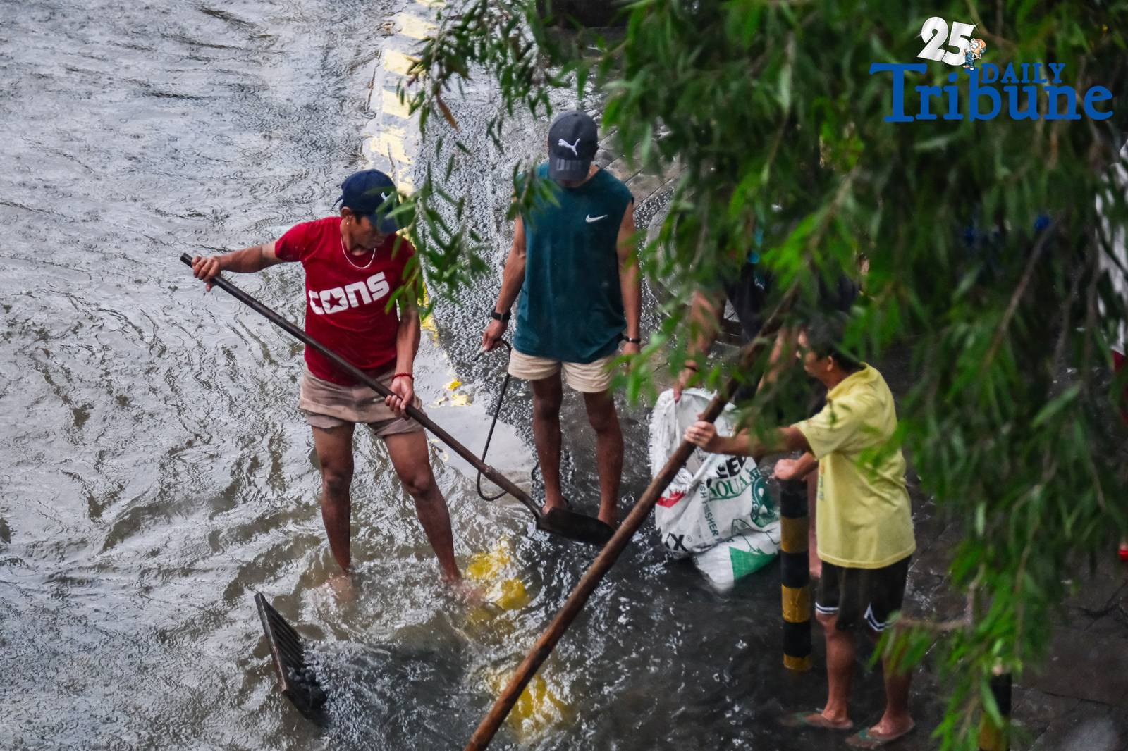Commuters go about their day in Manila despite the unrelenting downpour.