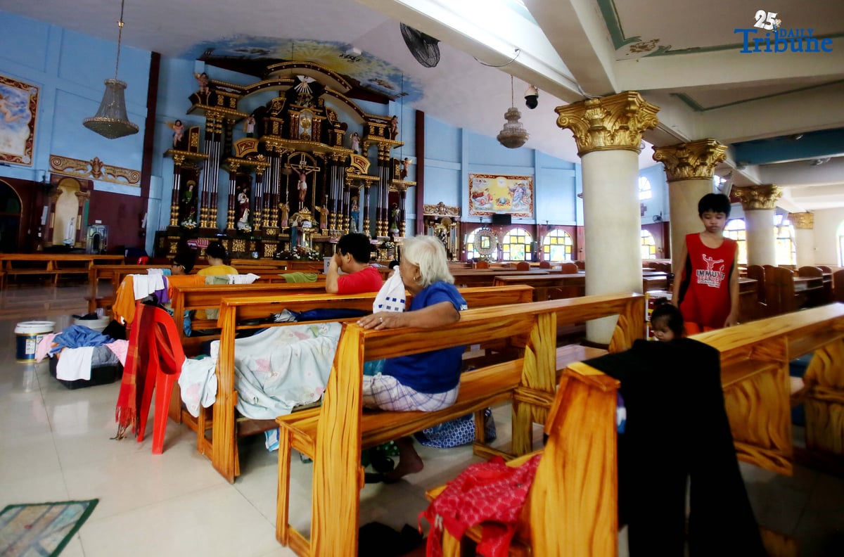 Evacuees take temporary shelter at Santa Lucia Parish in Barangay Sta. Lucia, Novaliches, Quezon City on Tuesday, July 22, 2025, after rising waters from Tullahan River submerged homes amid nonstop rains brought by the southwest monsoon.