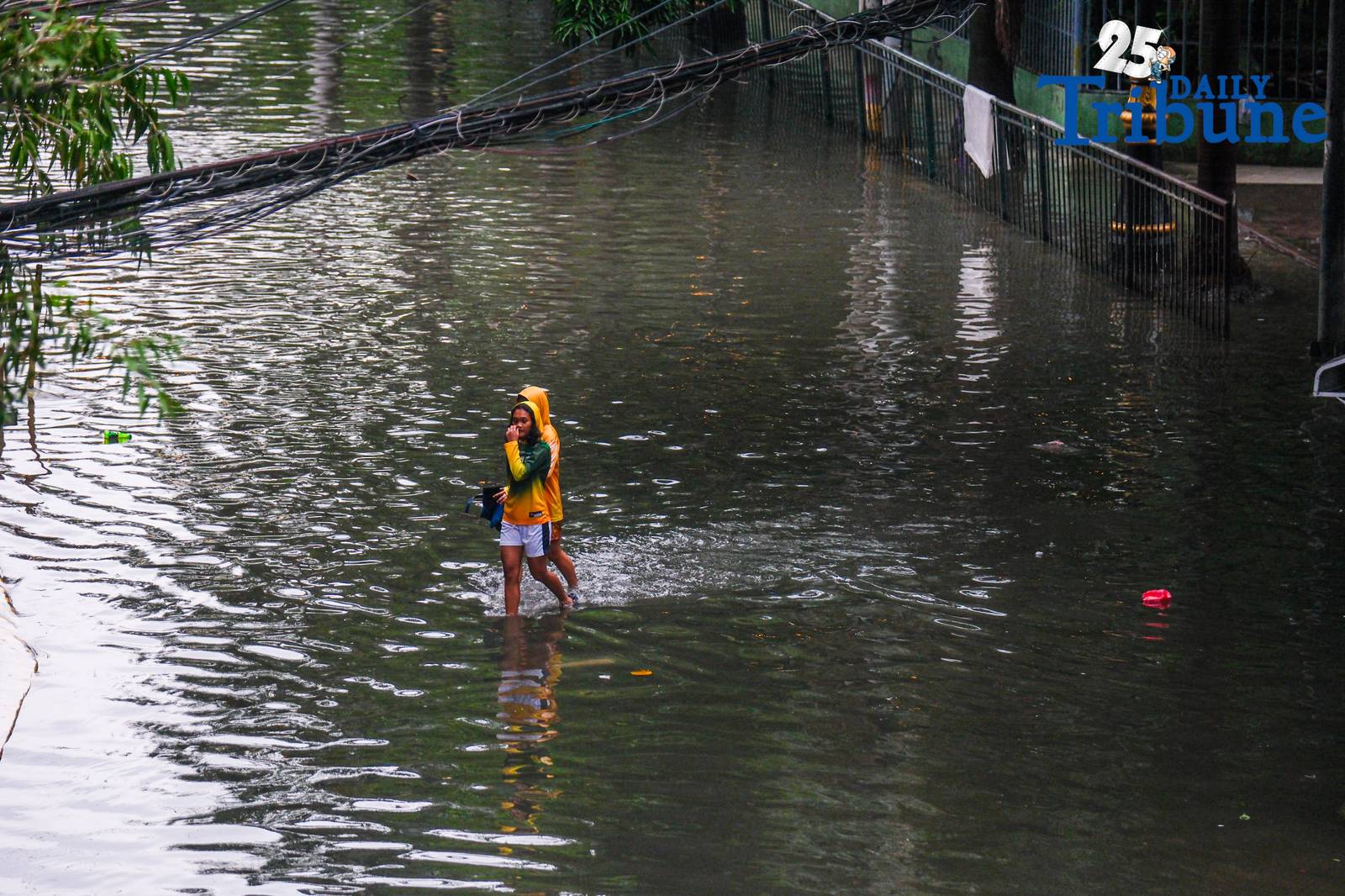 Commuters go about their day in Manila despite the unrelenting downpour.