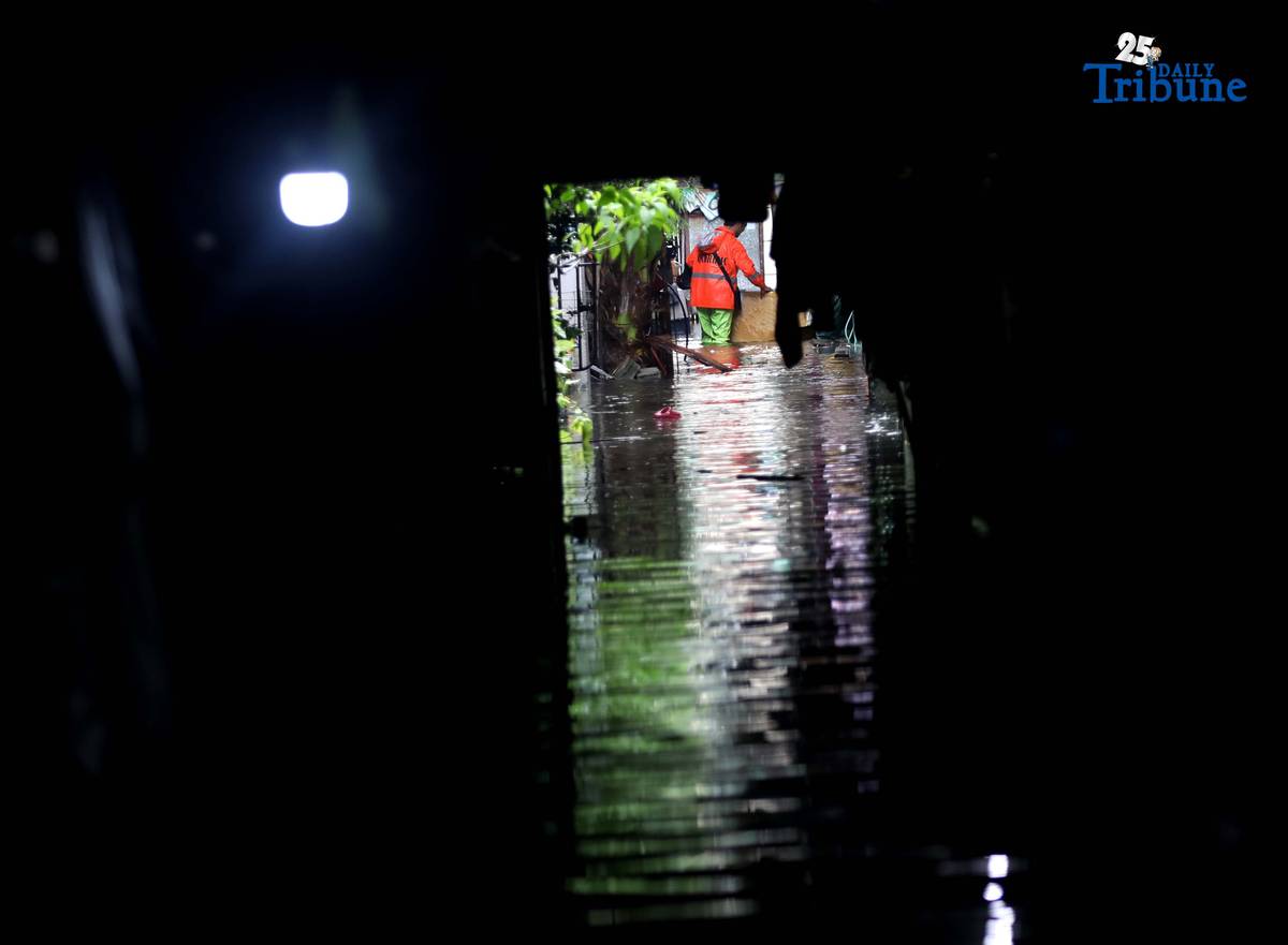 Residents in Barangay Rincon, Valenzuela City wade through flooded roads on July 22, 2025, as continuous rains submerge parts of the area. The southwest monsoon, or habagat, is expected to bring more moderate to heavy rainfall across Metro Manila, Luzon, and parts of the Visayas over the next three days, according to PAGASA.
