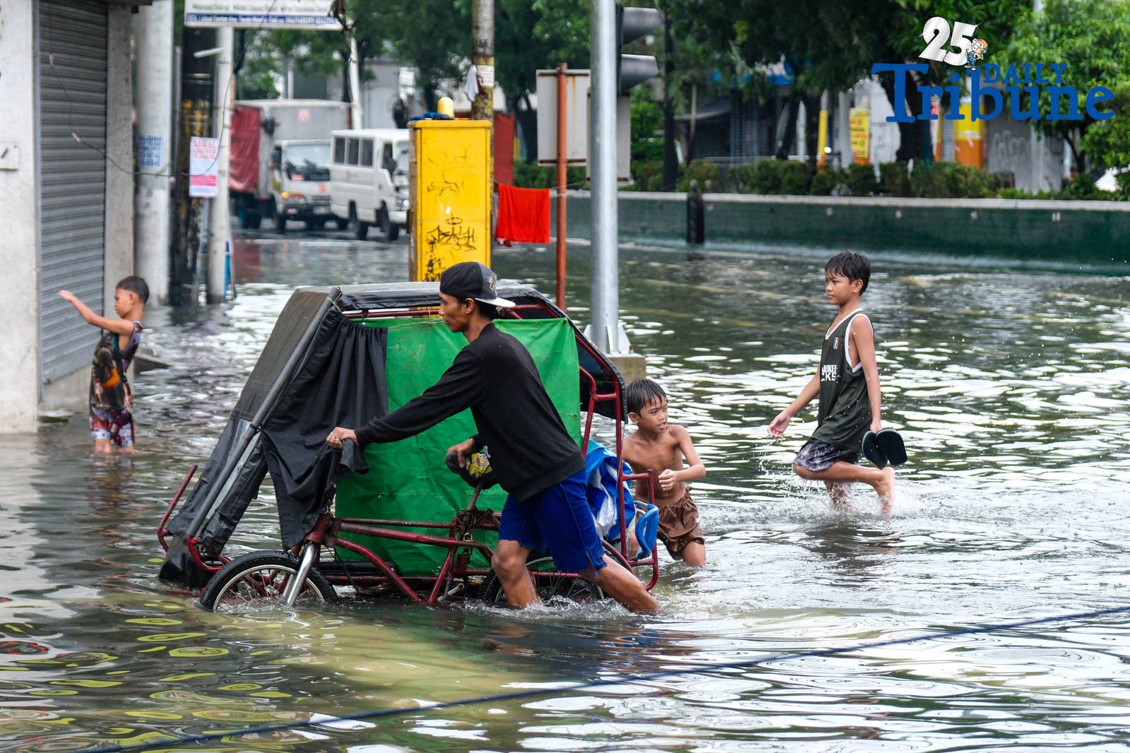 Commuters go about their day in Manila despite the unrelenting downpour.
