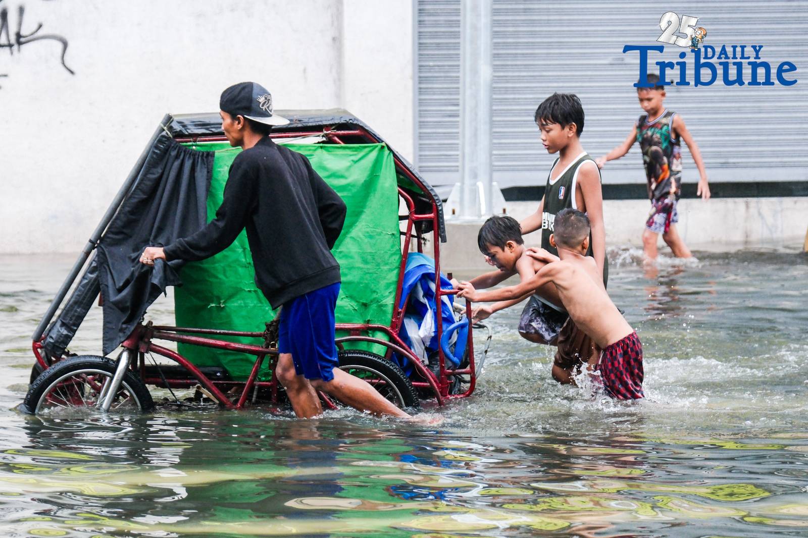 Commuters go about their day in Manila despite the unrelenting downpour.