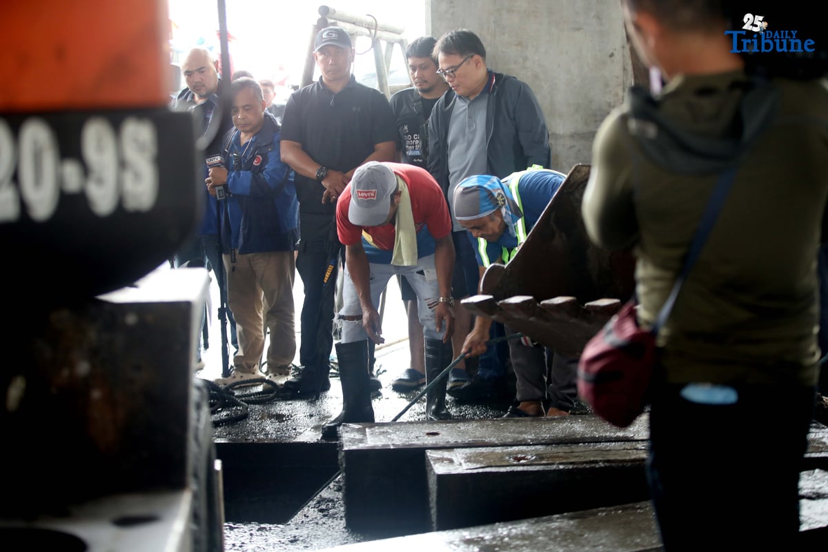 MMDA Chairman Atty. Don Artes inspects a manhole and oversees the clearing of garbage that contributed to flooding near MRT-7 Batasan Station along Commonwealth Avenue in Quezon City on Wednesday, July 23, 2025.