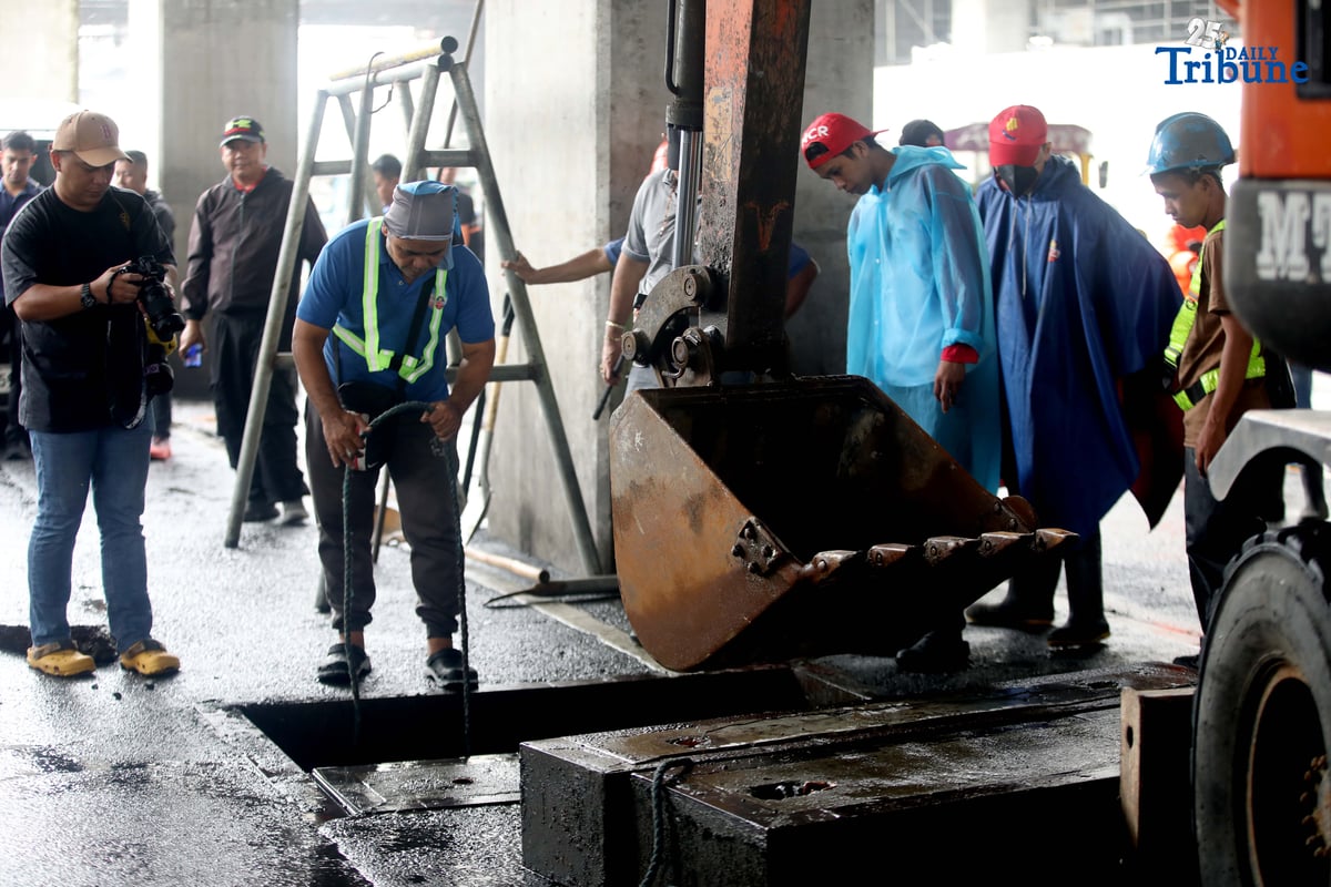 MMDA Chairman Atty. Don Artes inspects a manhole and oversees the clearing of garbage that contributed to flooding near MRT-7 Batasan Station along Commonwealth Avenue in Quezon City on Wednesday, July 23, 2025.