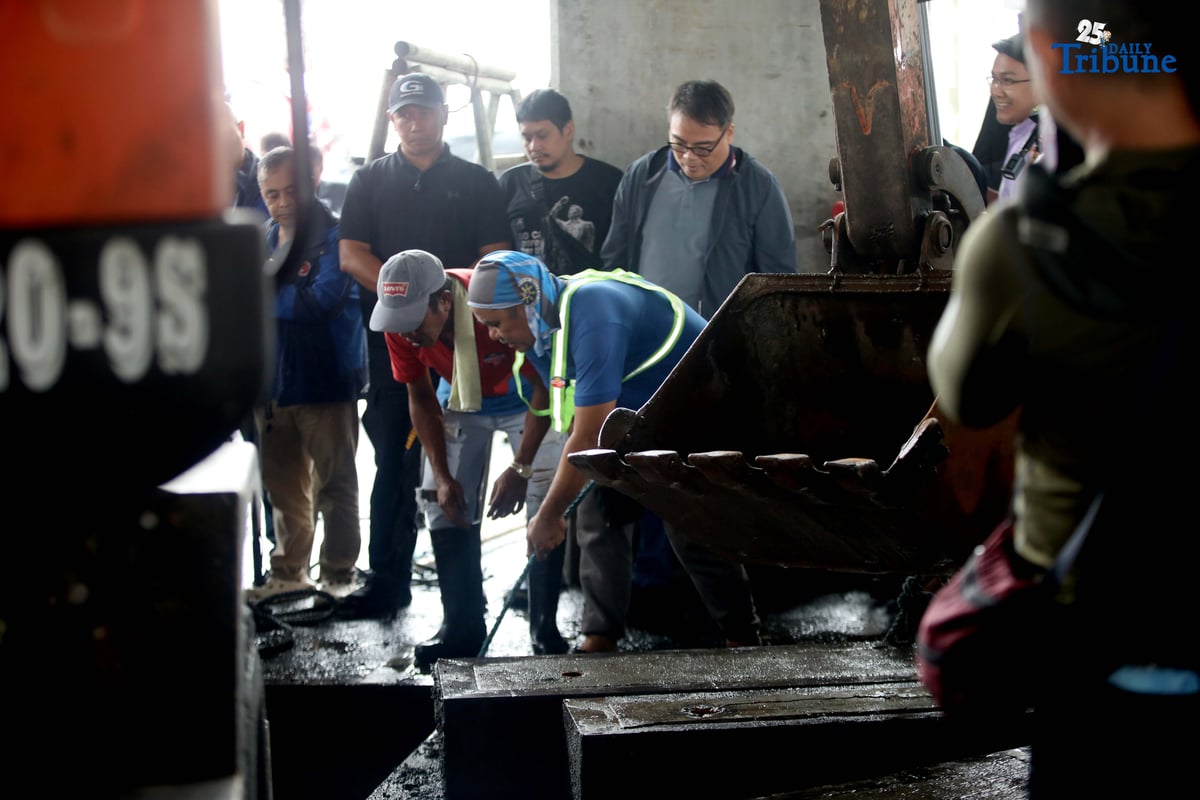 MMDA Chairman Atty. Don Artes inspects a manhole and oversees the clearing of garbage that contributed to flooding near MRT-7 Batasan Station along Commonwealth Avenue in Quezon City on Wednesday, July 23, 2025.