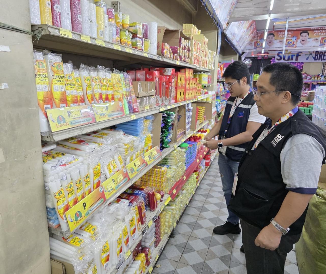 DTI-Fair Trade Enforcement Bureau personnel inspect prices in a grocery store in Cavite, following the pronouncement of a state of calamity in the province as a result of tropical cyclones ‘Crising’, ‘Dante’, ‘Emong’, as well as the southwest monsoon, or habagat, in the past days.