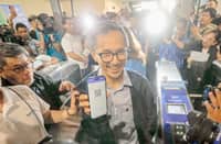 Department of Transportation Secretary Vince Dizon demonstrates the cashless payment option at the MRT-3 Ayala Station on Friday that is seen to improve the services of the mass transport system.
