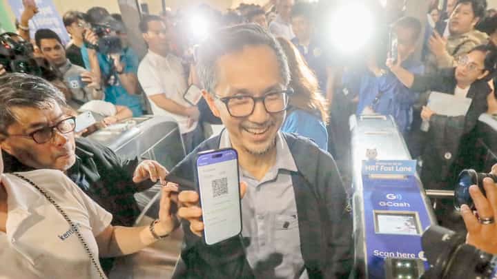 Department of Transportation Secretary Vince Dizon demonstrates the cashless payment option at the MRT-3 Ayala Station on Friday that is seen to improve the services of the mass transport system.
