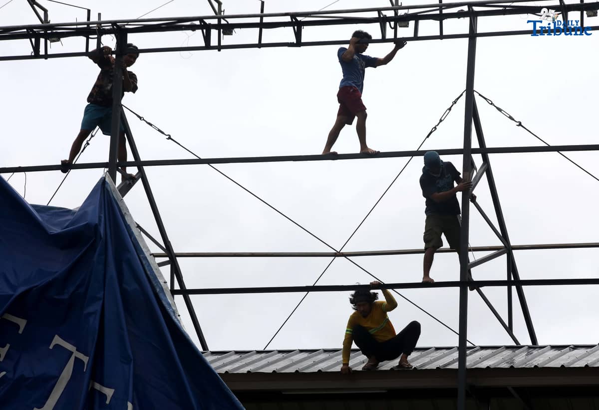 Workers were seen untying an outdoor advertisement along Commonwealth Avenue in Quezon City on Saturday morning. In a briefing past 5 AM, the Philippine Atmospheric, Geophysical, and Astronomical Services Administration (PAGASA) reported that Tropical Storm Emong (Co-may) weakened into a tropical depression as of 2 AM and exited the Philippine Area of Responsibility (PAR) at 7:10 AM.
