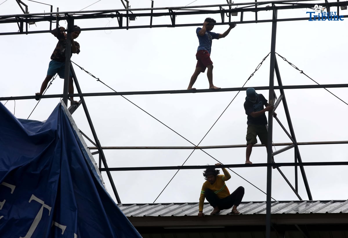 Workers were seen untying an outdoor advertisement along Commonwealth Avenue in Quezon City on Saturday morning. In a briefing past 5 AM, the Philippine Atmospheric, Geophysical, and Astronomical Services Administration (PAGASA) reported that Tropical Storm Emong (Co-may) weakened into a tropical depression as of 2 AM and exited the Philippine Area of Responsibility (PAR) at 7:10 AM.