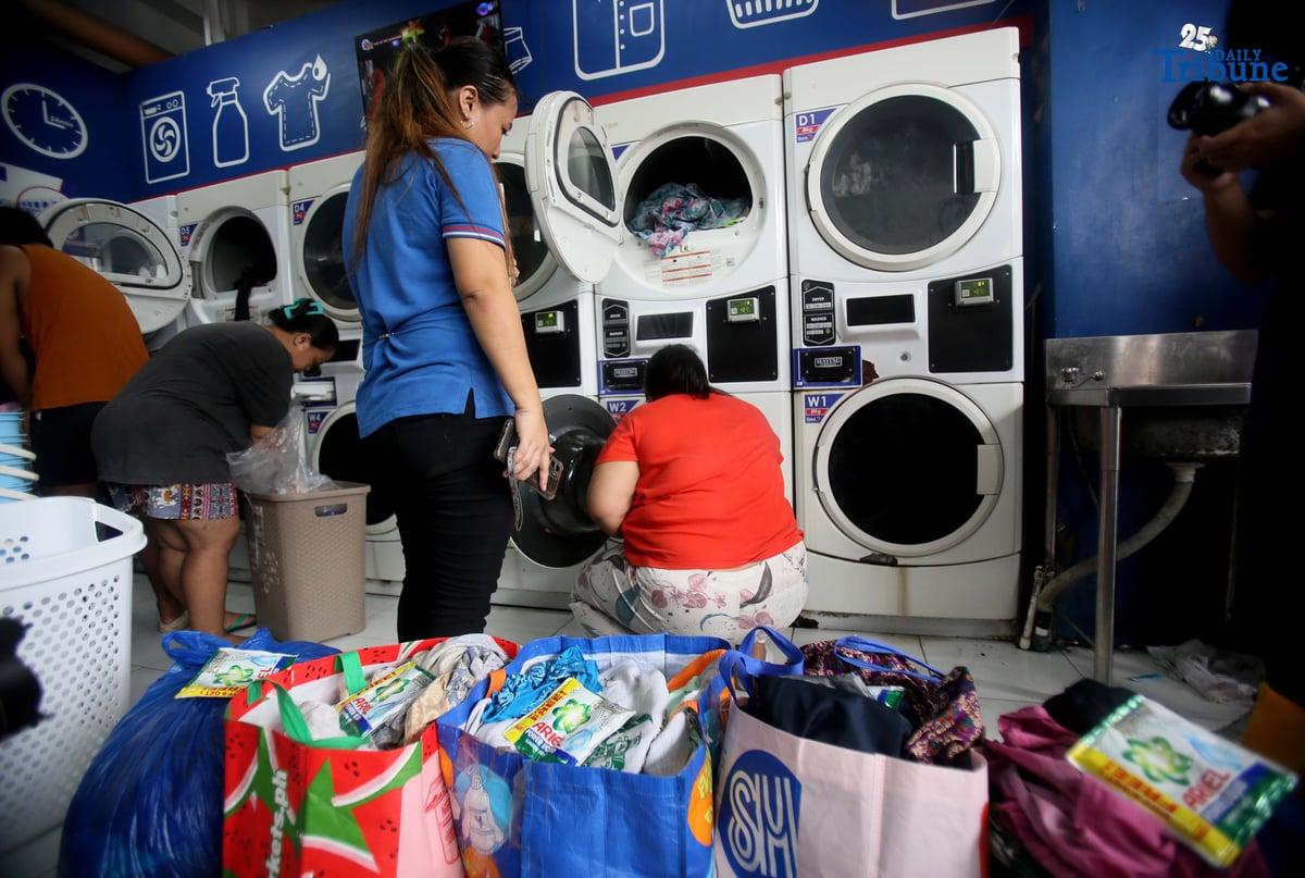 Residents near Nega-Qmart in Cubao, Quezon City, line up to avail of free laundry services at Save5 laundry center, part of Ariel Philippines' “Cycles of Care” initiative. The three-week relief program offers complimentary laundry services to families affected by recent typhoons and habagat rains across 30 branches in Metro Manila, in partnership with Save5.