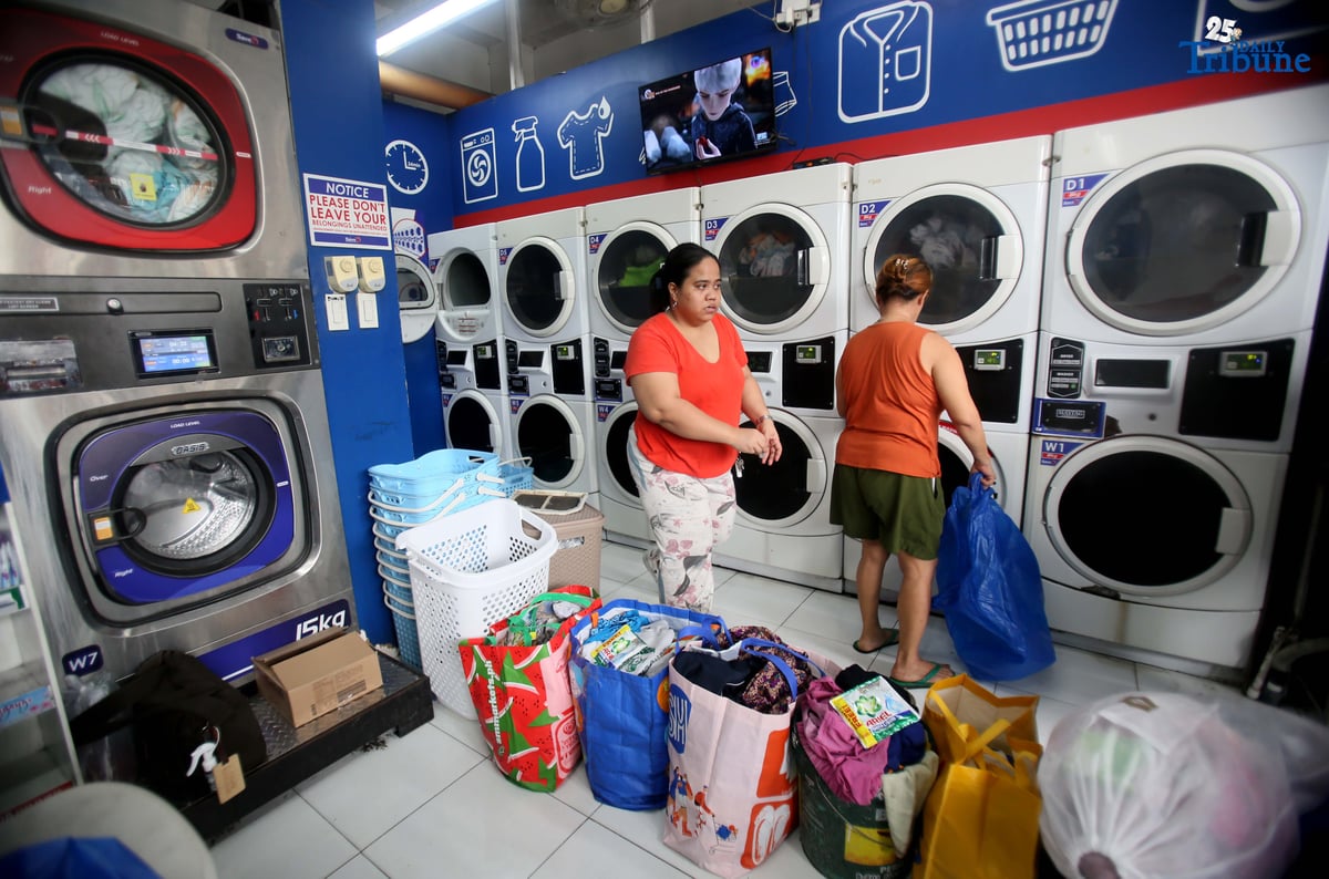 Residents near Nega-Qmart in Cubao, Quezon City, line up to avail of free laundry services at Save5 laundry center, part of Ariel Philippines' “Cycles of Care” initiative. The three-week relief program offers complimentary laundry services to families affected by recent typhoons and habagat rains across 30 branches in Metro Manila, in partnership with Save5.