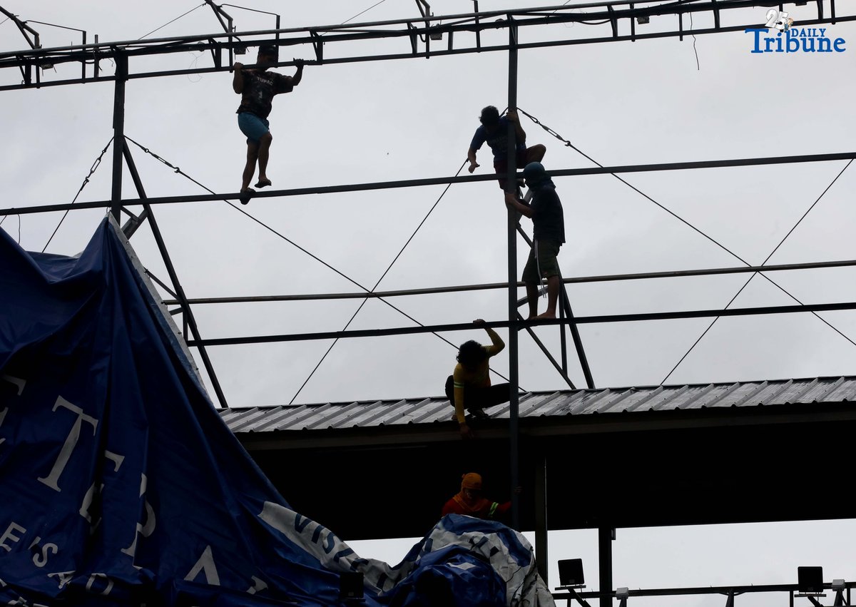 Workers were seen untying an outdoor advertisement along Commonwealth Avenue in Quezon City on Saturday morning. In a briefing past 5 AM, the Philippine Atmospheric, Geophysical, and Astronomical Services Administration (PAGASA) reported that Tropical Storm Emong (Co-may) weakened into a tropical depression as of 2 AM and exited the Philippine Area of Responsibility (PAR) at 7:10 AM.