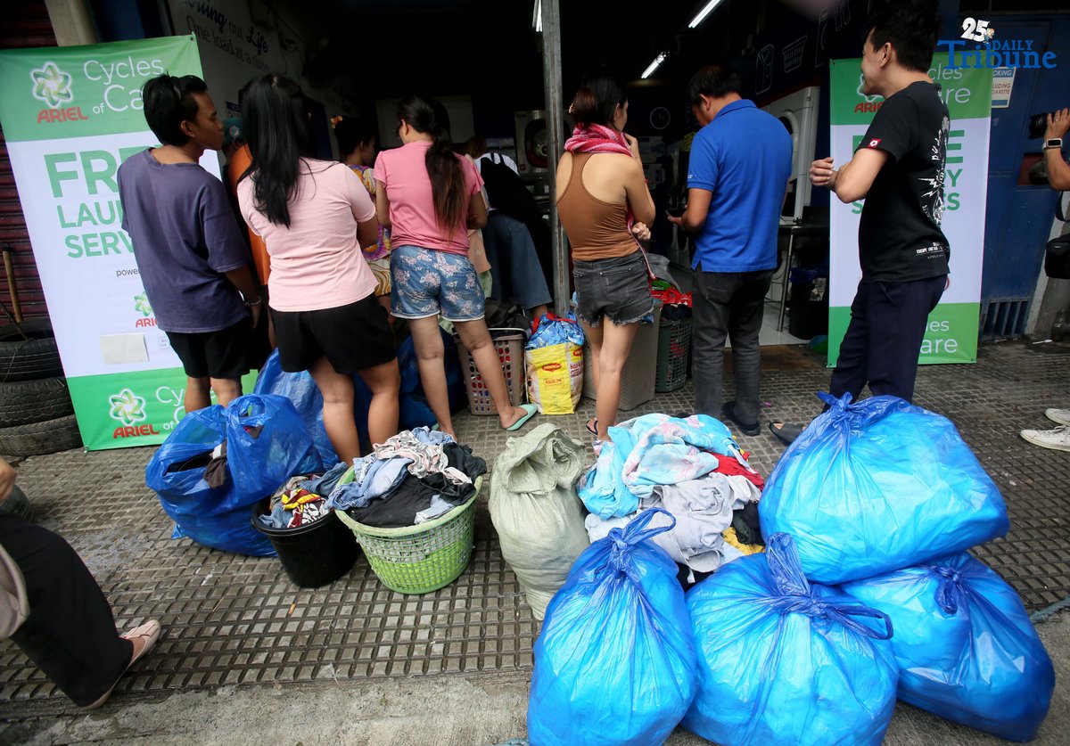Residents near Nega-Qmart in Cubao, Quezon City, line up to avail of free laundry services at Save5 laundry center, part of Ariel Philippines' “Cycles of Care” initiative. The three-week relief program offers complimentary laundry services to families affected by recent typhoons and habagat rains across 30 branches in Metro Manila, in partnership with Save5.
