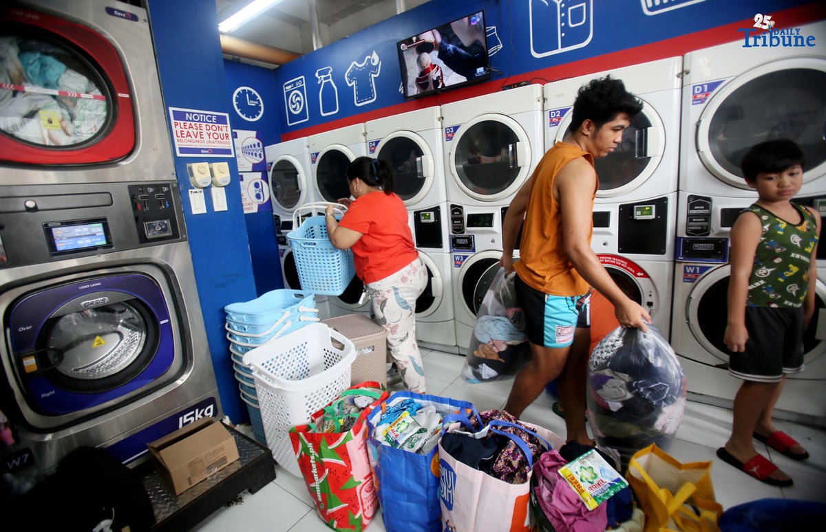 Residents near Nega-Qmart in Cubao, Quezon City, line up to avail of free laundry services at Save5 laundry center, part of Ariel Philippines' “Cycles of Care” initiative. The three-week relief program offers complimentary laundry services to families affected by recent typhoons and habagat rains across 30 branches in Metro Manila, in partnership with Save5.