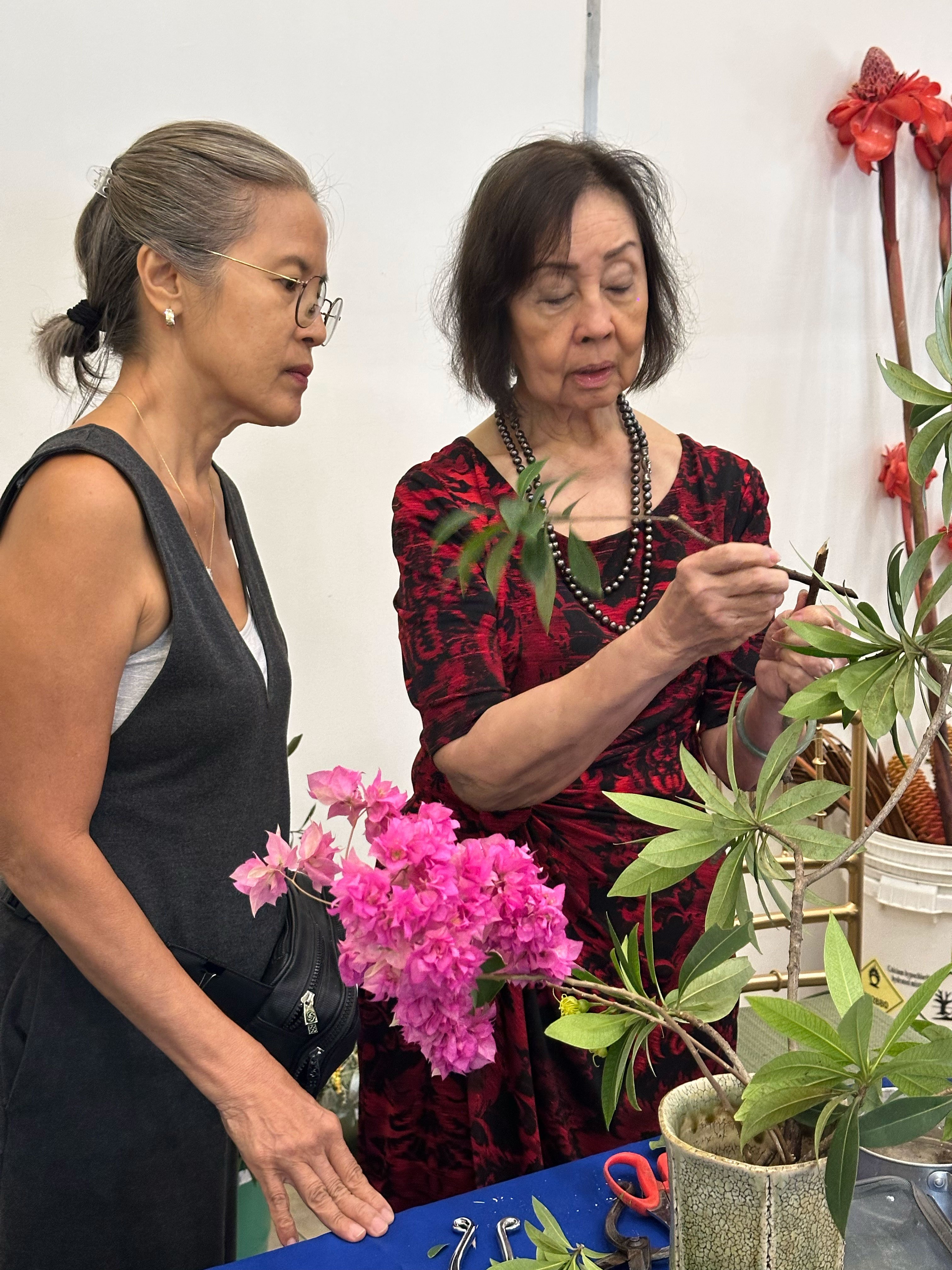 Ikebana Sogetsu teacher Evangeline Cheng (right) shares some tips and pointers to Diana Lozano.